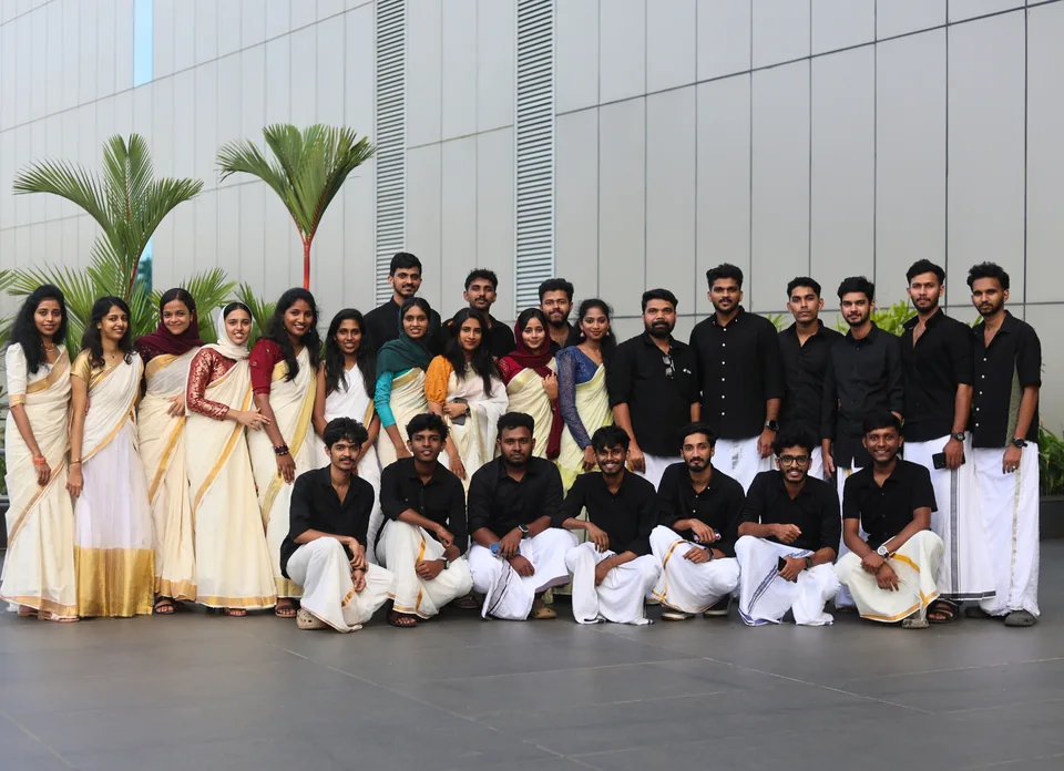Trogon teammates gathered outside in traditional Kerala attire