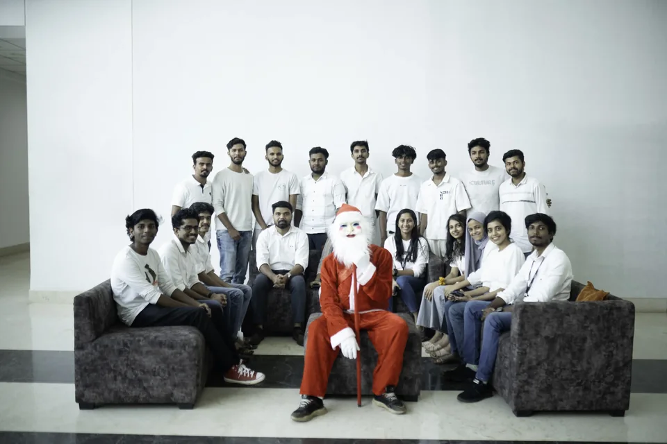 Trogon colleagues posing with Santa at their office Christmas celebration