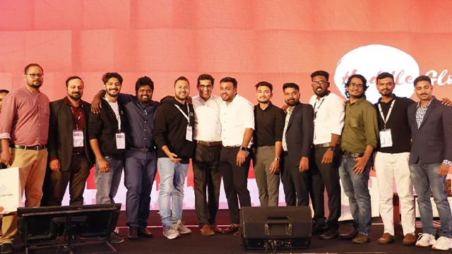 A group photo on stage at an industry event