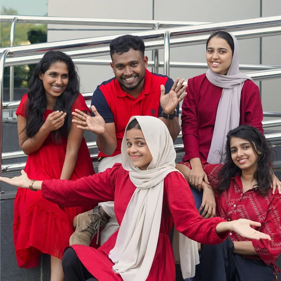 Trogon colleagues sharing a lighthearted moment on the office steps